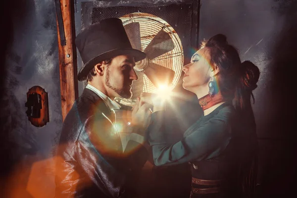 Pretty flirting couple dressed in vintage costumes on the dark room background. — Stock Photo, Image