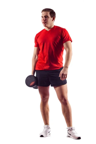 Muskulös kille gör övningar med hantlar över vita bak — Stockfoto