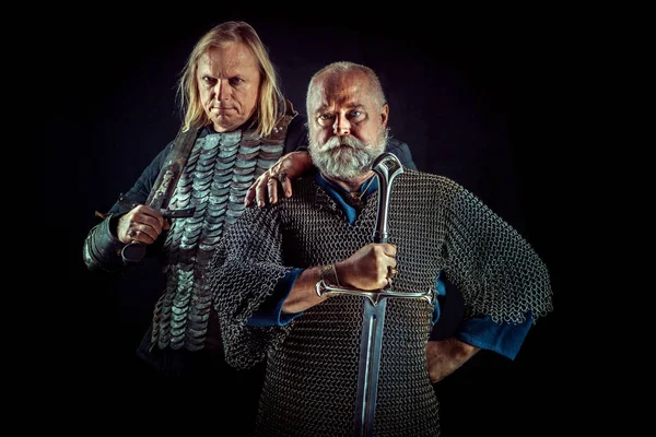 Two powerful knights with the swords on the dark background — Stock Photo, Image