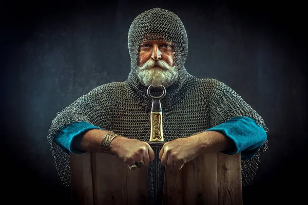 Powerful bearded knight with the dagger on the dark background — Stock Photo, Image