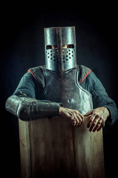 Powerful blond knight in the helmet on the dark background. — Stock Photo, Image