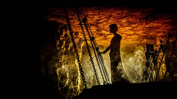 Silhouette of a mysterious witch on the suspension bridge with clouds of smoke around her. — Stock Photo, Image