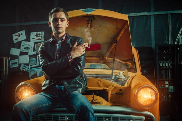 Smart-Fahrer sitzt auf seinem alten Auto in der Garage — Stockfoto