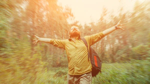 Portrait of a bearded backpacker with rucksack on the forest background — Stock Photo, Image