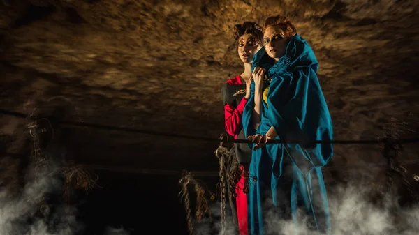 Mysterious witches on the suspension bridge in the dungeon. — Stock Photo, Image
