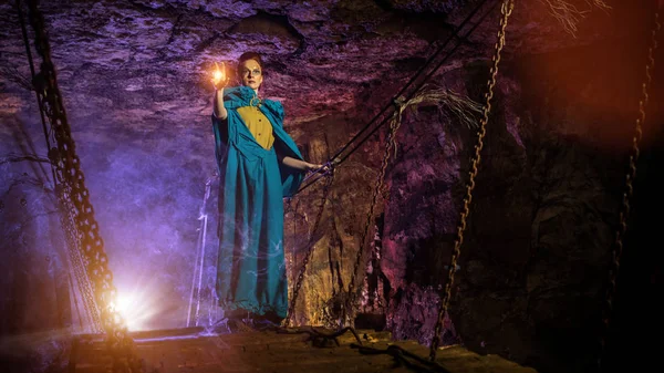 Mysterious witch on the suspension bridge in the dungeon. — Stock Photo, Image