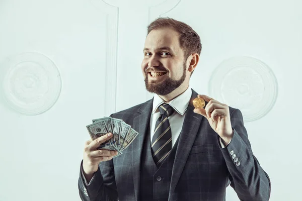 Uomo d'affari in possesso di Bitcoin d'oro, Ticker Symbol BTC e banconote in dollari, finanza denaro bitcoin concetto . — Foto Stock