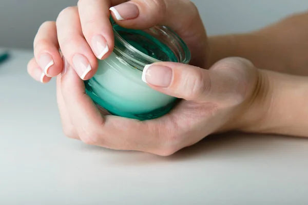 Beautiful woman hands with cream — Stock Photo, Image