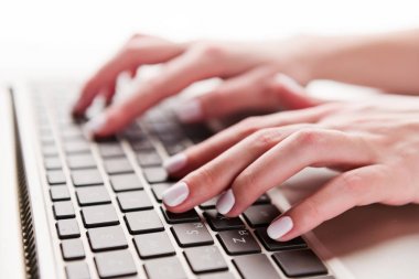 Close-up of typing female hands on keyboard of computer clipart