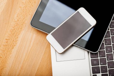 Ahşap masa üzerinde telefon ve tablet pc ile klavye