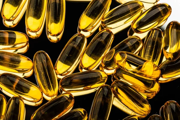 Omega 3 gel capsules on black — Stock Photo, Image