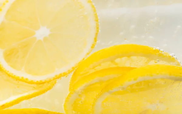 Slices of lemon in water — Stock Photo, Image