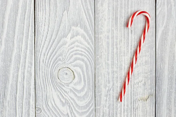 Christmas cane on wooden background — Stock Photo, Image