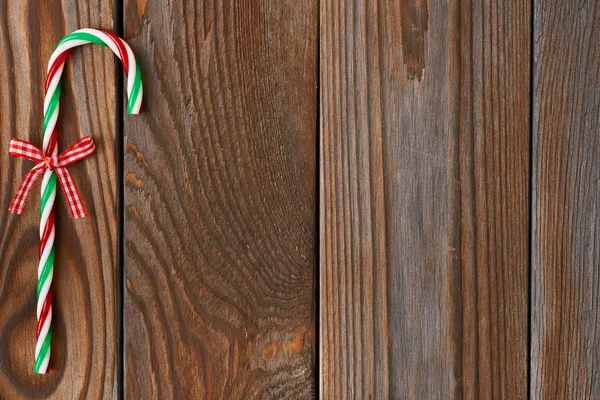 Christmas cane on wooden background — Stock Photo, Image