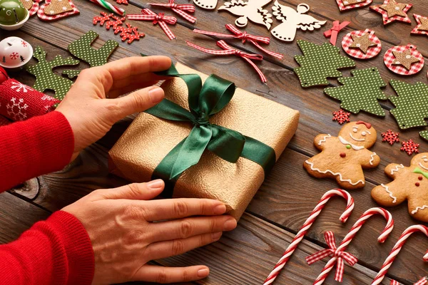 Mãos femininas sobre presente de Natal — Fotografia de Stock