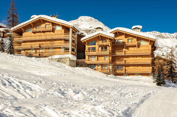 Alpine winter mountain landscape with chalet