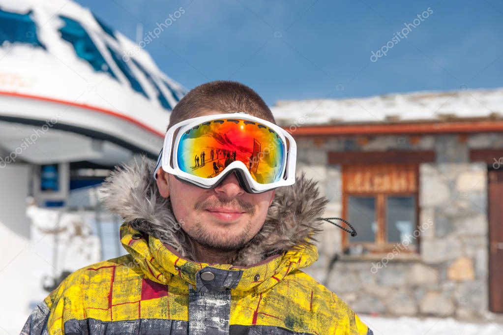 Young man in ski goggles outdoors