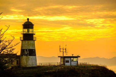 Cape Disappointment Lighthouse at sunrise clipart