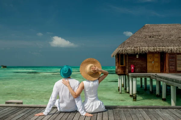 Casal em um molhe de praia em Maldivas — Fotografia de Stock