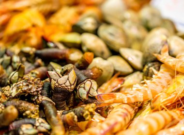 Langoustinesand shells at seafood market clipart