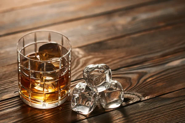 Glass of whiskey with ice cubes — Stock Photo, Image