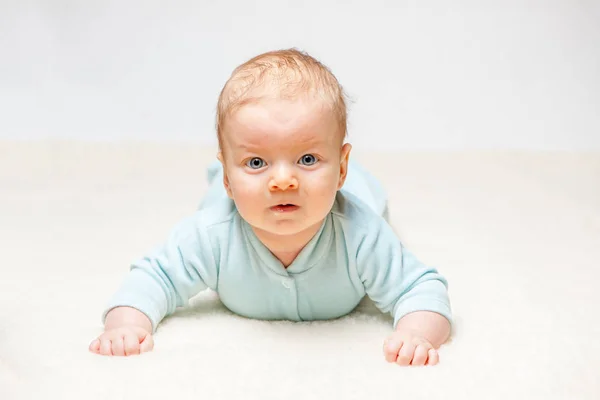 Baby liggend op beige cover — Stockfoto