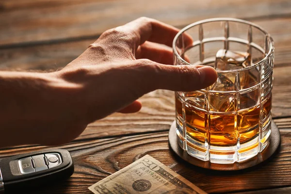 Mano maschile raggiungere per il vetro con whisky — Foto Stock