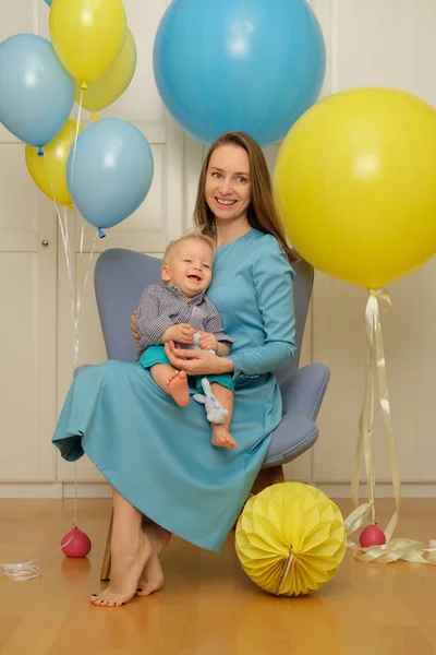 Enfant en bas âge avec sa mère assise sur une chaise — Photo