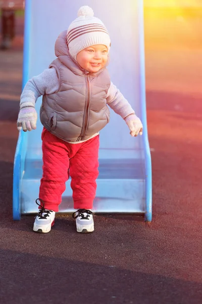 Boy toddler at playground slide — Stock Photo, Image