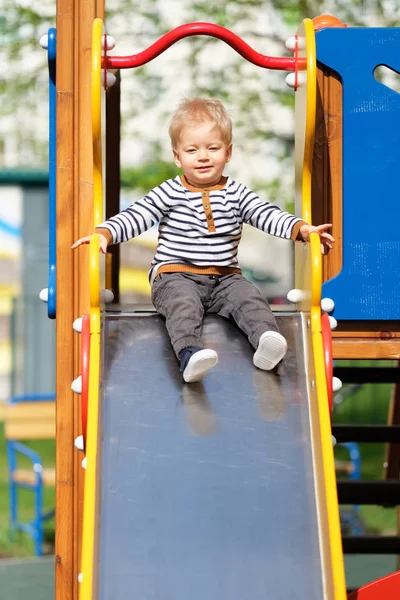 Toddler boy at playground slide — Stock Photo, Image