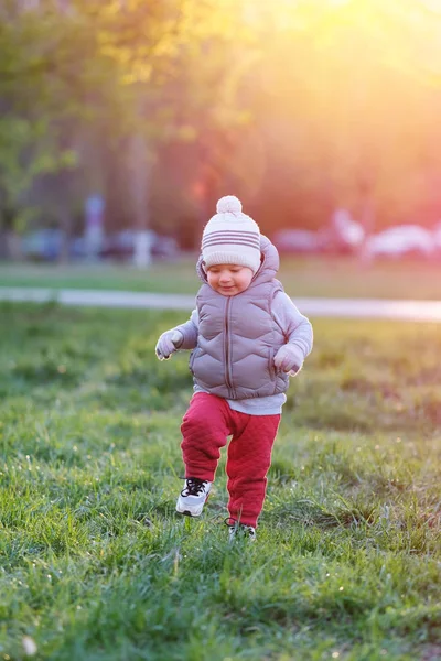 Child in jacket walking in park — Stock Photo, Image