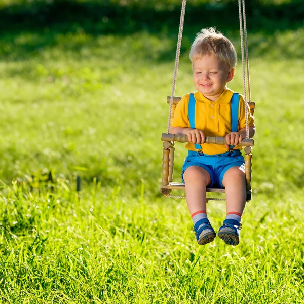 Boy swinging on teeterboard — Stock Photo, Image