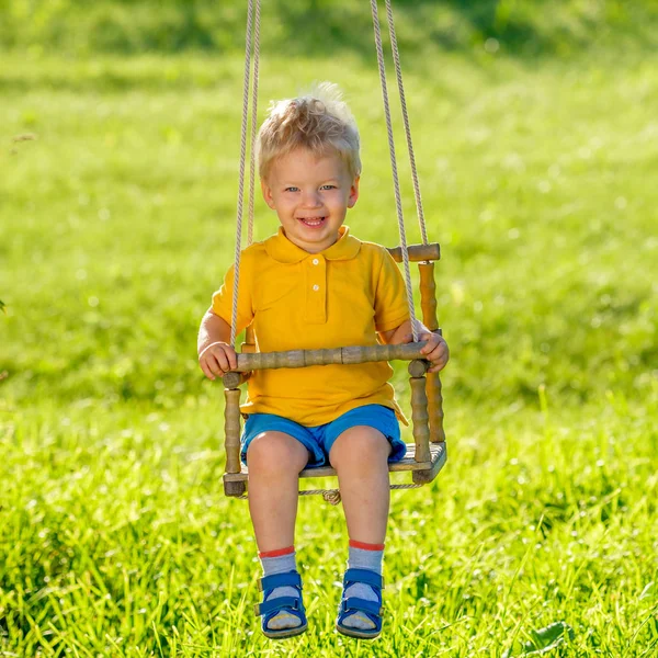 Toddler boy swinging — Stock Photo, Image