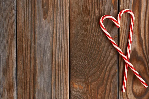 Christmas cane on wood background — Stock Photo, Image