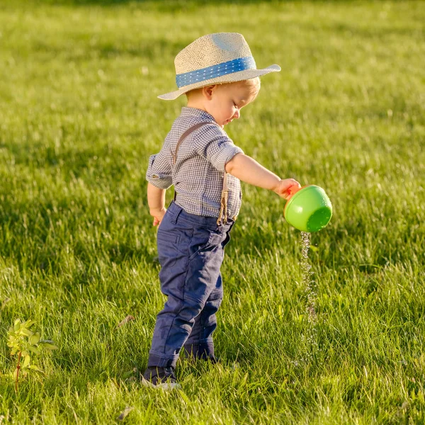 Toddler boy using watering can — Stock Photo, Image