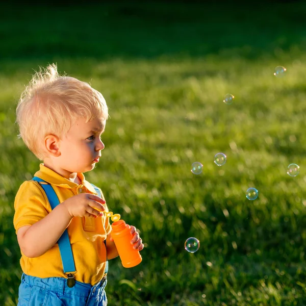 Baby boy blowing bubbles — Stock Photo, Image