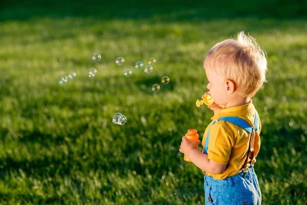 Baby boy blowing soap bubbles — Stock Photo, Image