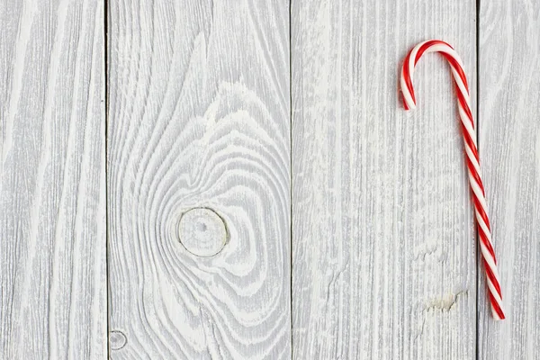 Christmas cane decoration on wood — Stock Photo, Image