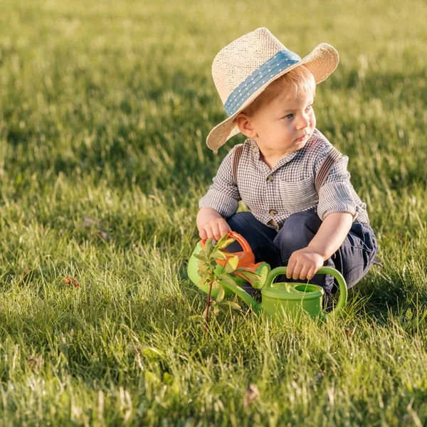 Toddler boy using watering can — Stock Photo, Image