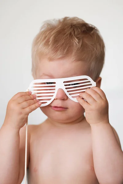 Baby boy with paper glasses on stick — Stock Photo, Image