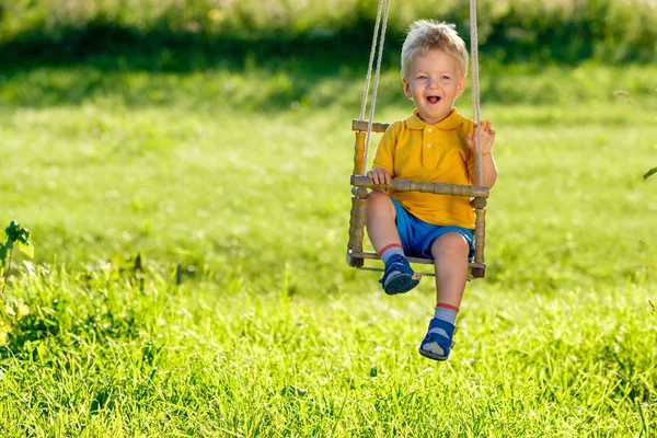 Toddler boy swinging — Stock Photo, Image