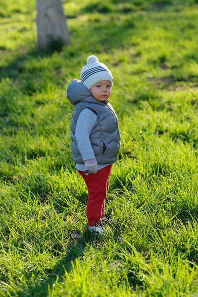 Smiling boy in warm jacket at sunset — Stock Photo, Image