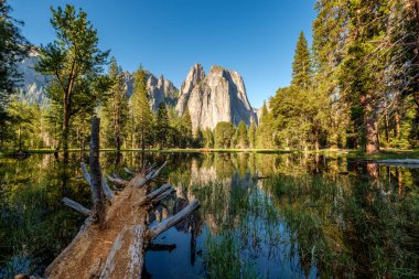 Middle Cathedral Rock reflecting in Merced River at Yosemite National Park. California, USA. clipart