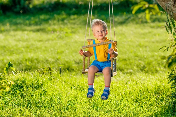 Portrait of toddler swinging outdoors — Stock Photo, Image