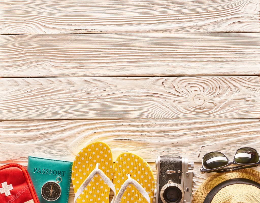 Travel and beach items still life over wooden background with copy space