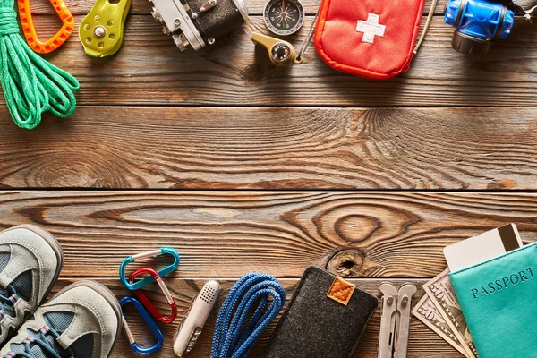 Travel items for hiking tourism still life over wooden background