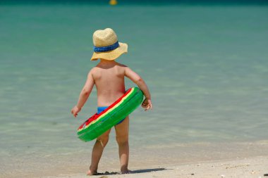 Kumsalda eğleniyor iki yaşında bir yürümeye başlayan çocuk 