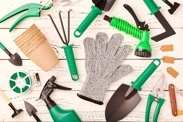 Gardening tools on wooden background flat lay — Stock Photo, Image