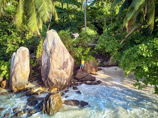 Man on beach at Seychelles air top view — стокове фото