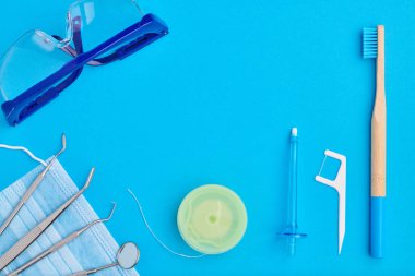 Dişçi araçları mavi arkaplan üst görünümü üzerinde